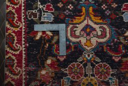 Backside of handmade 2000s Shiraz rug showing knot structure and weave density