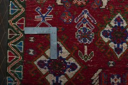 Backside of handmade 2000s Shiraz rug showing knot structure and weave density