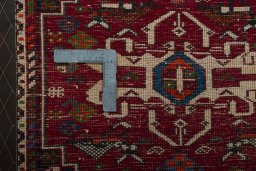 Backside of handmade 2000s Shiraz rug showing knot structure and weave density