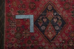 Backside of handmade 2000s Shiraz rug showing knot structure and weave density