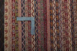 Backside of handmade 2000s Shiraz rug showing knot structure and weave density