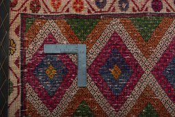 Backside of handmade 2000s Shiraz rug showing knot structure and weave density