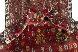 Corner detail of 2000s Shiraz rug showing border pattern and Wool pile