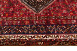 Corner detail of 2000s Shiraz rug showing border pattern and Wool pile