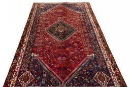 Surface texture of 2000s Shiraz rug with natural Wool and intricate pattern