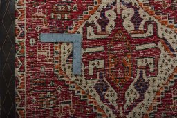 Backside of handmade 2000s Shiraz rug showing knot structure and weave density
