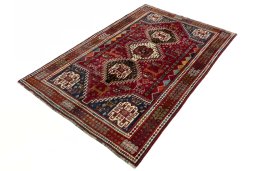 Corner detail of 2000s Shiraz rug showing border pattern and Wool pile