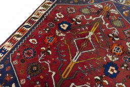 Backside of handmade 2000s Shiraz rug showing knot structure and weave density