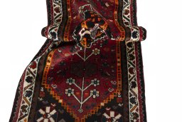 Corner detail of 2000s Shiraz rug showing border pattern and Wool pile