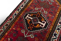 Backside of handmade 2000s Shiraz rug showing knot structure and weave density