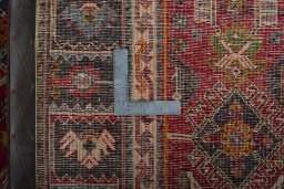 Backside of handmade 2000s Shiraz rug showing knot structure and weave density