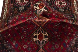 Corner detail of 2000s Shiraz rug showing border pattern and Wool pile