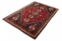 Corner detail of 2000s Shiraz rug showing border pattern and Wool pile