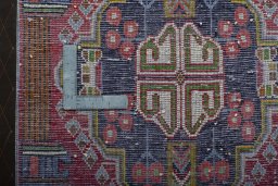 Backside of handmade 2000s Shiraz rug showing knot structure and weave density