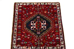 Surface texture of 2000s Shiraz rug with natural Wool and intricate pattern
