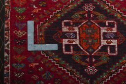 Backside of handmade 2000s Shiraz rug showing knot structure and weave density