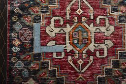 Backside of handmade 2000s Shiraz rug showing knot structure and weave density