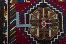 Backside of handmade 2000s Shiraz rug showing knot structure and weave density