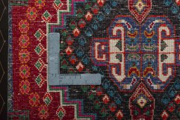 Backside of handmade 2000s Shiraz rug showing knot structure and weave density