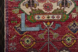 Backside of handmade 2000s Shiraz rug showing knot structure and weave density
