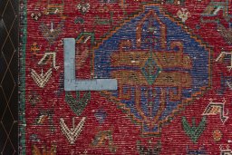 Backside of handmade 2000s Shiraz rug showing knot structure and weave density
