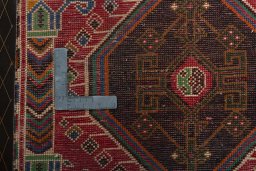Backside of handmade 2000s Shiraz rug showing knot structure and weave density