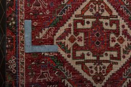 Backside of handmade 2000s Shiraz rug showing knot structure and weave density