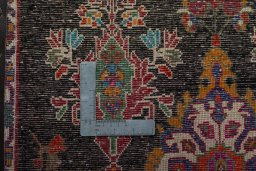 Backside of handmade 2000s Shiraz rug showing knot structure and weave density