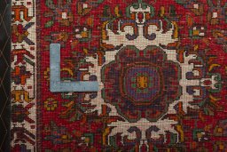 Backside of handmade 2000s Shiraz rug showing knot structure and weave density
