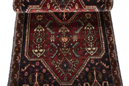 Corner detail of 2000s Shiraz rug showing border pattern and Wool pile