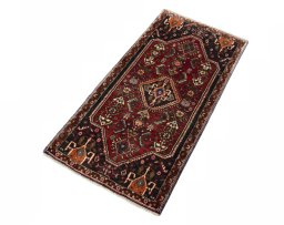 Corner detail of 2000s Shiraz rug showing border pattern and Wool pile