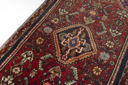 Backside of handmade 2000s Shiraz rug showing knot structure and weave density