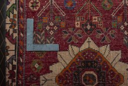 Backside of handmade 2000s Shiraz rug showing knot structure and weave density