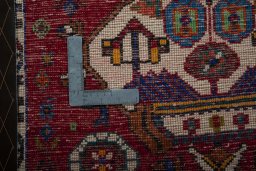 Backside of handmade 2000s Shiraz rug showing knot structure and weave density