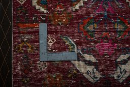 Backside of handmade 2000s Shiraz rug showing knot structure and weave density