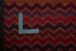 Backside of handmade 2000s Shiraz rug showing knot structure and weave density