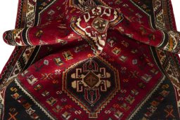 Corner detail of 2000s Shiraz rug showing border pattern and Wool pile