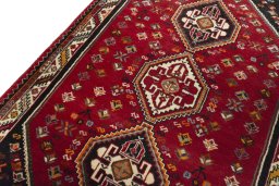 Backside of handmade 2000s Shiraz rug showing knot structure and weave density