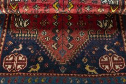 Corner detail of 2000s Shiraz rug showing border pattern and Wool pile
