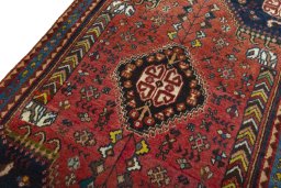 Backside of handmade 2000s Shiraz rug showing knot structure and weave density