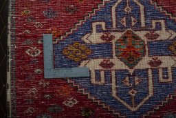 Backside of handmade 2000s Shiraz rug showing knot structure and weave density