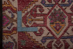Backside of handmade 2000s Shiraz rug showing knot structure and weave density