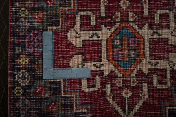 Backside of handmade 2000s Shiraz rug showing knot structure and weave density