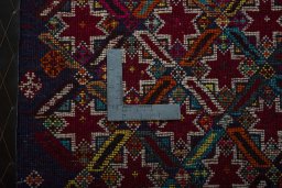 Backside of handmade 2000s Shiraz rug showing knot structure and weave density