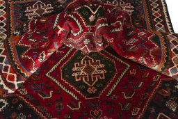Corner detail of 2000s Shiraz rug showing border pattern and Wool pile