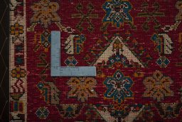 Backside of handmade 2000s Shiraz rug showing knot structure and weave density