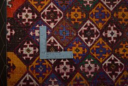 Backside of handmade 2000s Shiraz rug showing knot structure and weave density