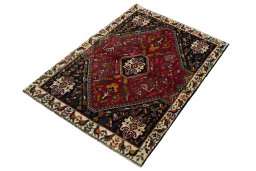 Corner detail of 2000s Shiraz rug showing border pattern and Wool pile