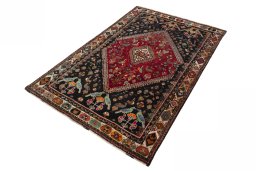 Corner detail of 2000s Shiraz rug showing border pattern and Wool pile