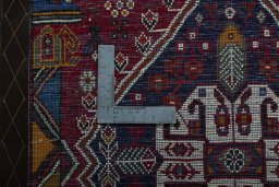 Backside of handmade 2000s Shiraz rug showing knot structure and weave density